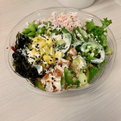 Salmon poke bowl with seaweed salad and fresh jalapeños