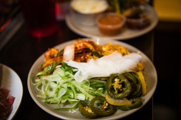 Sides. Scallion and onion salad, jalapenos, sliced radish, kimchi