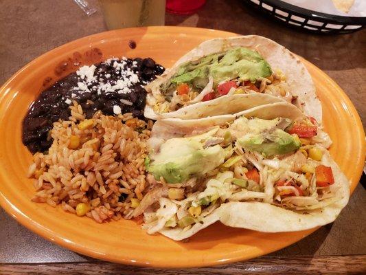 Fish taco dish with black beans and red rice.