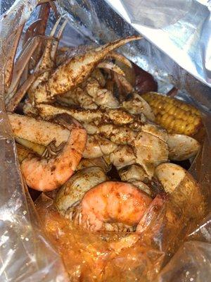 Headless shrimp, snow crab, corn, clams. Medium heat and their crackin sauce