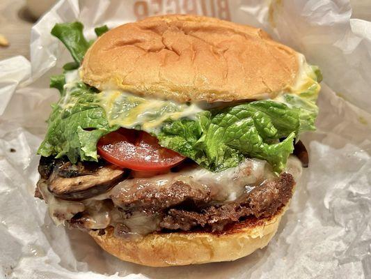 Double Truffle Mushroom Swiss Burger. Two thick meat patty with crimini mushrooms. Messy but it tastes great in all its truffle pungency.