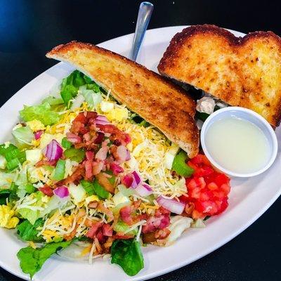 1/2 chicken salad sandwich and the salad expressoria with a toast triangle.