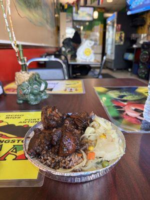 Jerk chicken, rice and peas, cabbage, oxtail gravy, sweet sauce