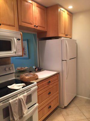 Kitchen with double ovens, microwave and pass through to dining area.