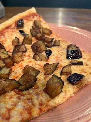 Two slices of pizza with eggplant