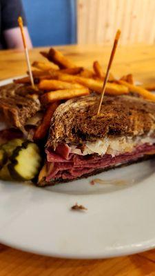 A Reuben Sandwich with pickles & fries