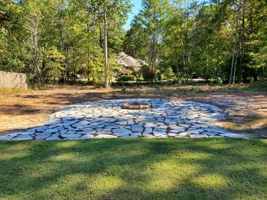 25ish foot back yard with 5 foot fire pit.