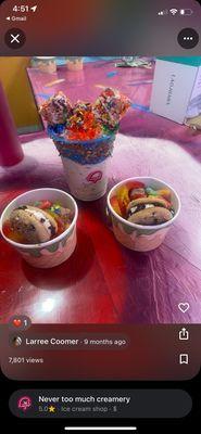 Two scoops of ice cream topped with cookies and candy.