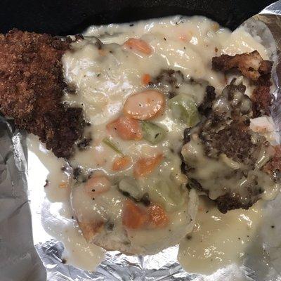 Fried chicken Breast on biscuit with pot pie gravy over cooked