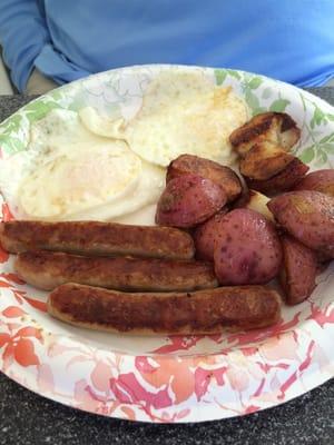 2 egg breakfast with sausage and home fries and toast.