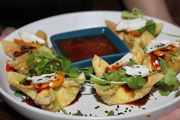 The Cheese Rangoon with Colossal Crab is made with colossal crab, pineapple sweet & sour, chile, scallion, cilantro, & fesno chile