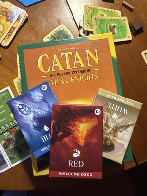 Catan cities and Knights expansion pack, three magic starter decks