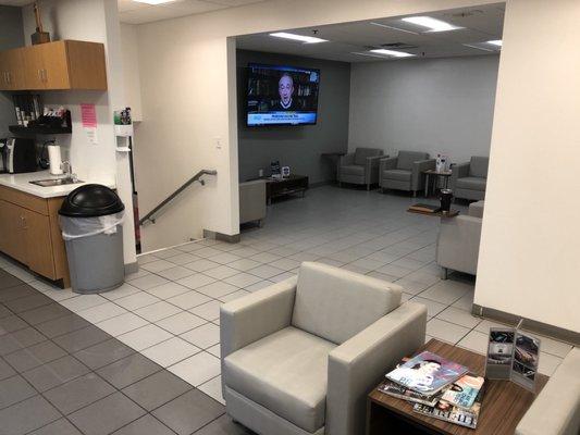 Very nice waiting area with a big TV, comfy chairs and desk areas with power for laptops and phones