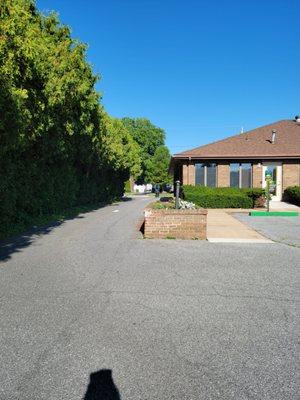 When facing the street side of the office, to the right is a driveway entrance to the rear of the office with additional parking (one way)