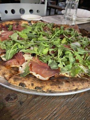 White pizza with prosciutto and arugula