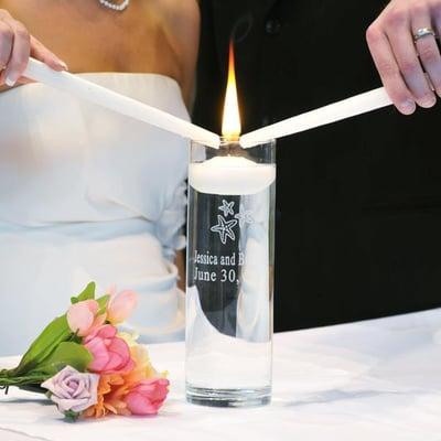 Two separate flames, one for each family, are combined to symbolize the uniting of two families as one.