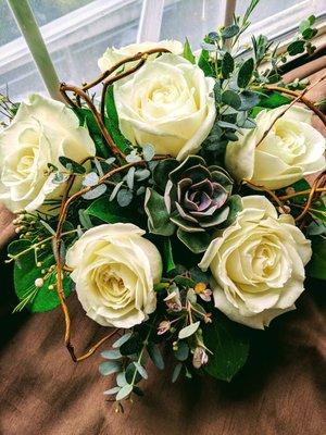 Cube arrangement with white roses, succulents arranged with beautiful mix greens.