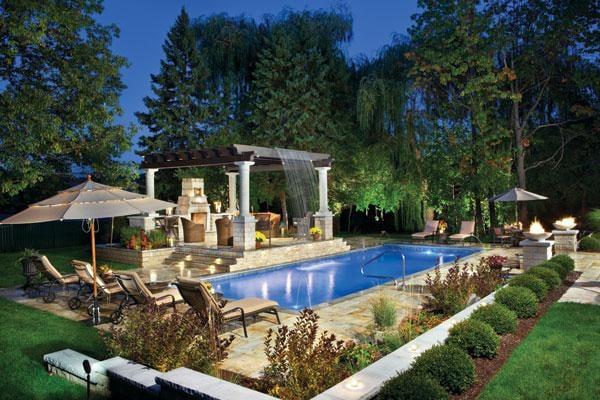 Rectangle pool with arbor over patio and beautiful landscaping