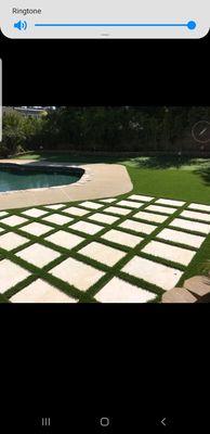 Patio sitting area created with 2x2' stepping stones and synthetic grass in between