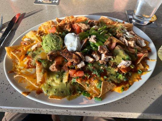 Yard House nachos with blackened chicken breast bigger and cheaper than sharkys.