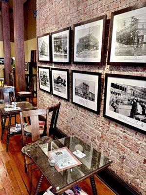 Some old wooden tables alongside the restored brick wall. The photos are Nihonmachi pre-WWII.