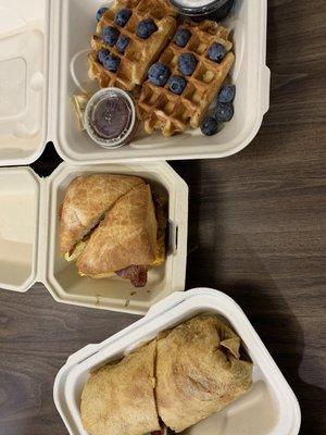 Sugar waffle, breakfast sandwich, chicken and egg breakfast burrito.