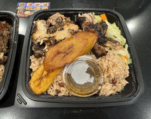 Jerk chicken (with side of sauce) with veggies, rice and plantains.