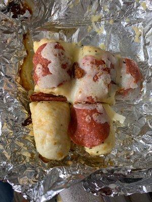 Loaded breadsticks: bites with pepperoni sitting on top...of some of them