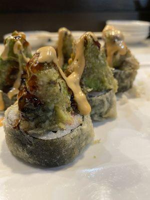 Monster Roll $13 Deep fried crab cream cheese in side, topped with chopped eel avocado crunch with eel sauce an spicy mayo.