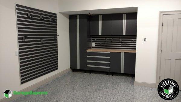 Black garage cabinets and slate wall with 1/4" Grey Epoxy Floor Coating System.