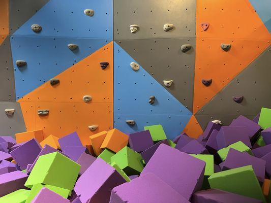 Foam pit with climbing wall