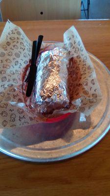 Chipotle burrito served on a metal dish and in a plastic basket. It was ok. Not bad but not great. A bit expensive. Rate it a "B-."