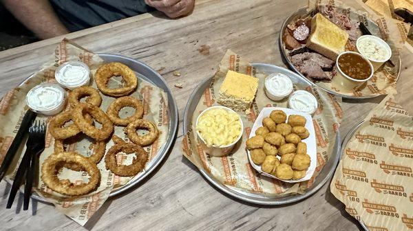 Onion rings, corn nuggets, Mac & Chs, corn bread, brisket, pulled pork, sausage, Texas toast, baked beans and Cole Slaw.