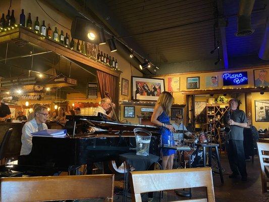 Tom Grant on piano, Phil Baker on bass, and Ron Steen on drums.  Owner (?) on sax.