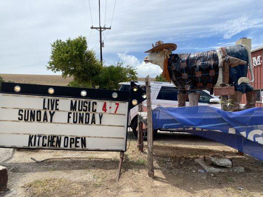 Sign and cow out front