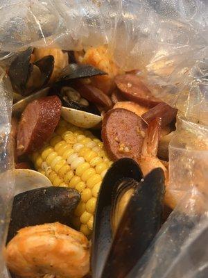 Boiled seafood in a bag-Combo B with added 1/2 pound sausage, medium Millions Special sauce