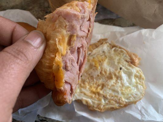 Ham egg and cheese on a croissant with pepper cheese