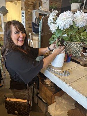 A talented customer putting together a floral arrangement