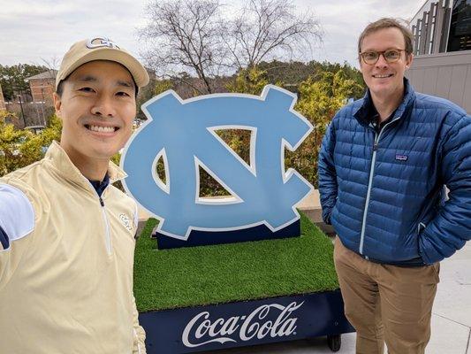 UNC logo on wheels, sponsored by Coca-Cola. Outside the Dean E. Smith Center, Entrance A.