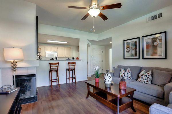 Spacious living room with wood-style vinyl plank flooring and access to patio.