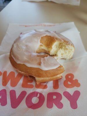 Frosted donut with very little frosting.