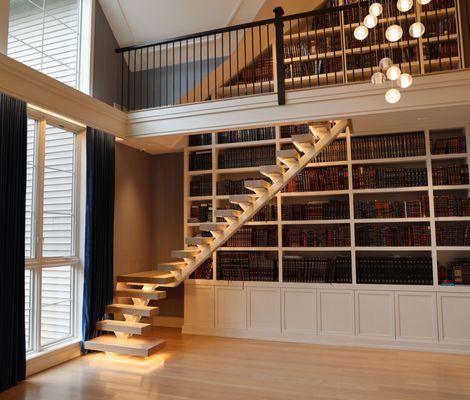 L-Shaped Single Stringer modern stair with thick wood treads and LED lighting.