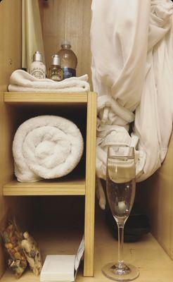 Spa locker fully equipped with comfy robe, towels, shower essentials, snacks, and sandals.