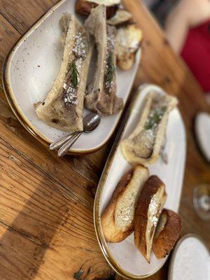 Fire roasted extra-long bone marrow canoe with cotija cheese, served with crostini