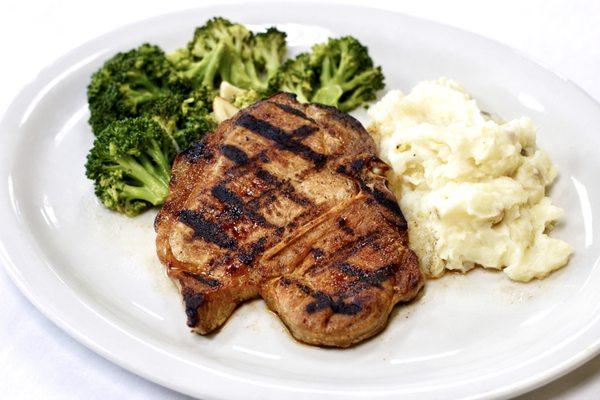 Chuleta Norteña- Grilled pork chops w/ mash potatoes and broccoli