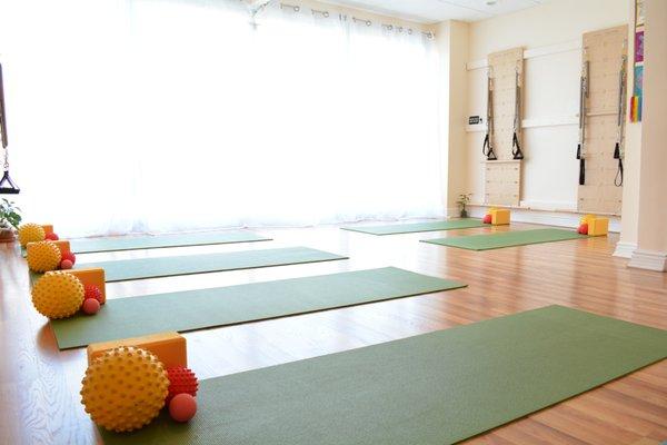 gorgeous floor to ceiling mat room with tons of props to help improve your posture