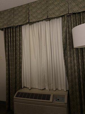 A/C and heater unit at window.