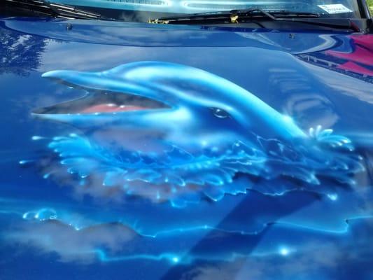 The hood of another car at show painted by Indy Body Werks with ocean theme.