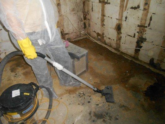 HEPA vacuuming the floor during a mold abatement project.