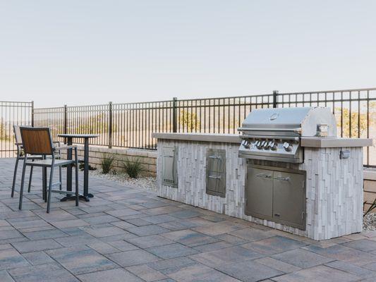 Custom built masonry kitchen island with stainless steel appliances